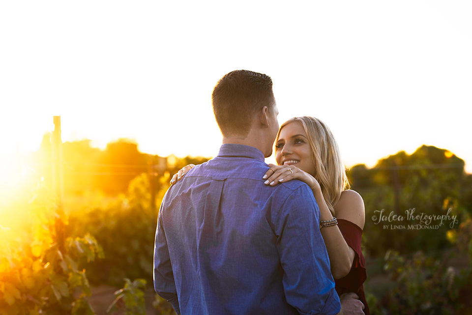 couple embracing in vineyard at Temecula winery