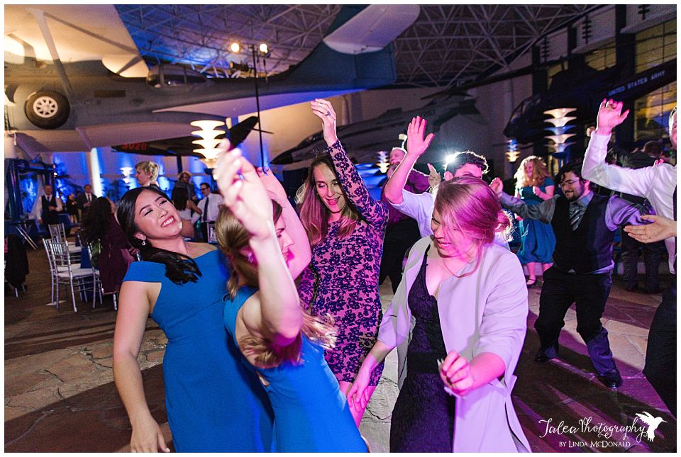 wedding reception guests dancing in a group