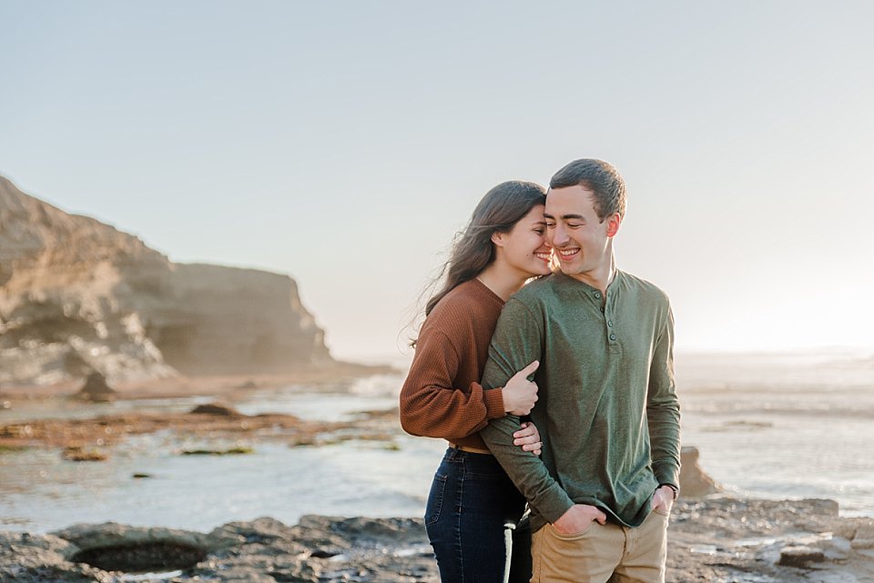 girl nuzzling guy in closely from behind san diego engagement photos