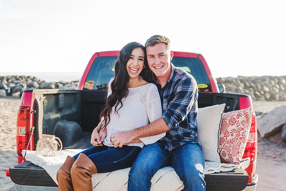 couple sitting truck bed san diego beach engagement photos