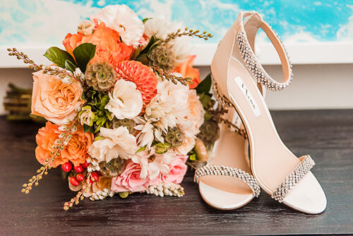 orange and peach flower bouquet and nina wedding shoes