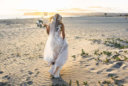 backside of bride walking towards coronado beach ca