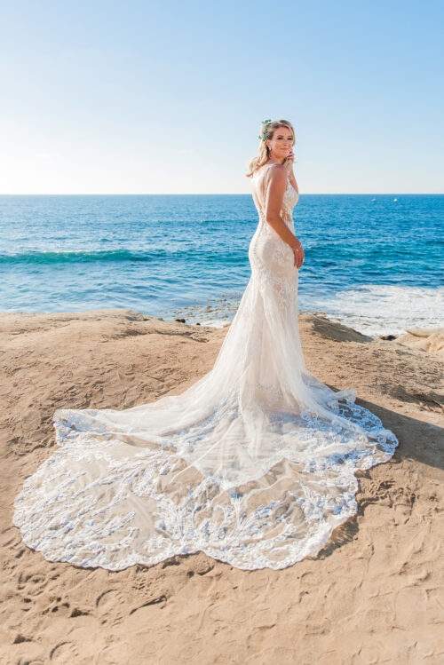 back view of blonde bride in wedding dress at La Jolla Shores CA beach
