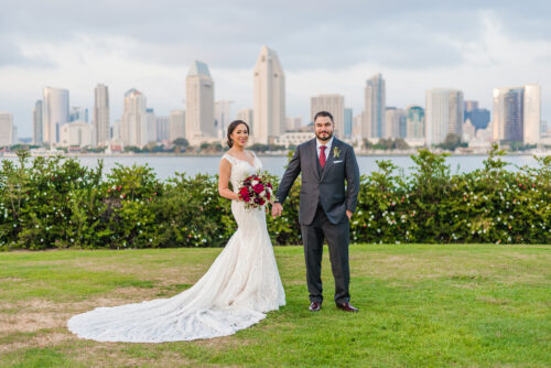 Bride and Groom standing in front of San Diego Skyline at Coronado CA Centennial Park