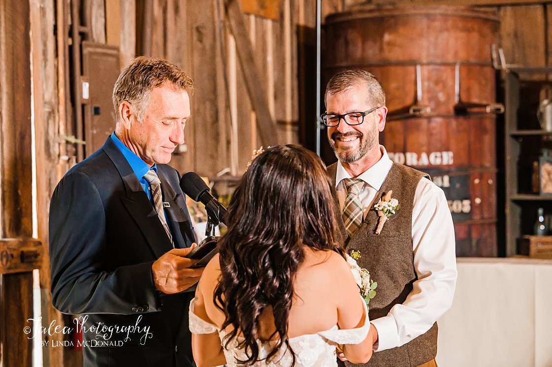 groom smiling at bride in Barrel Room at Bernardo Winery Southern California