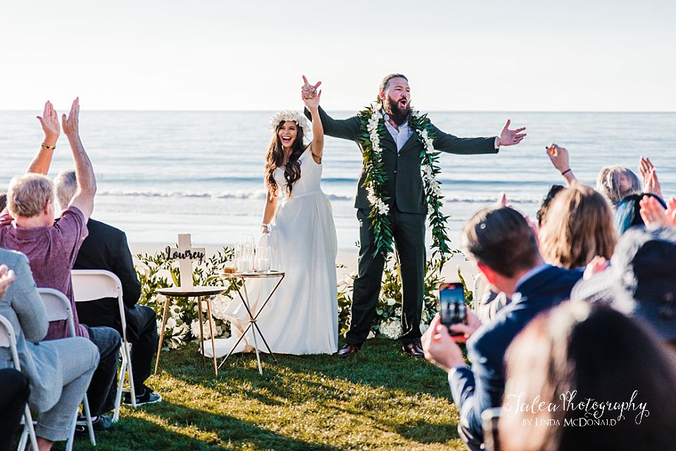 bride and groom show their excitement during a wedding ceremony at Scripps Seaside Formum La Jolla