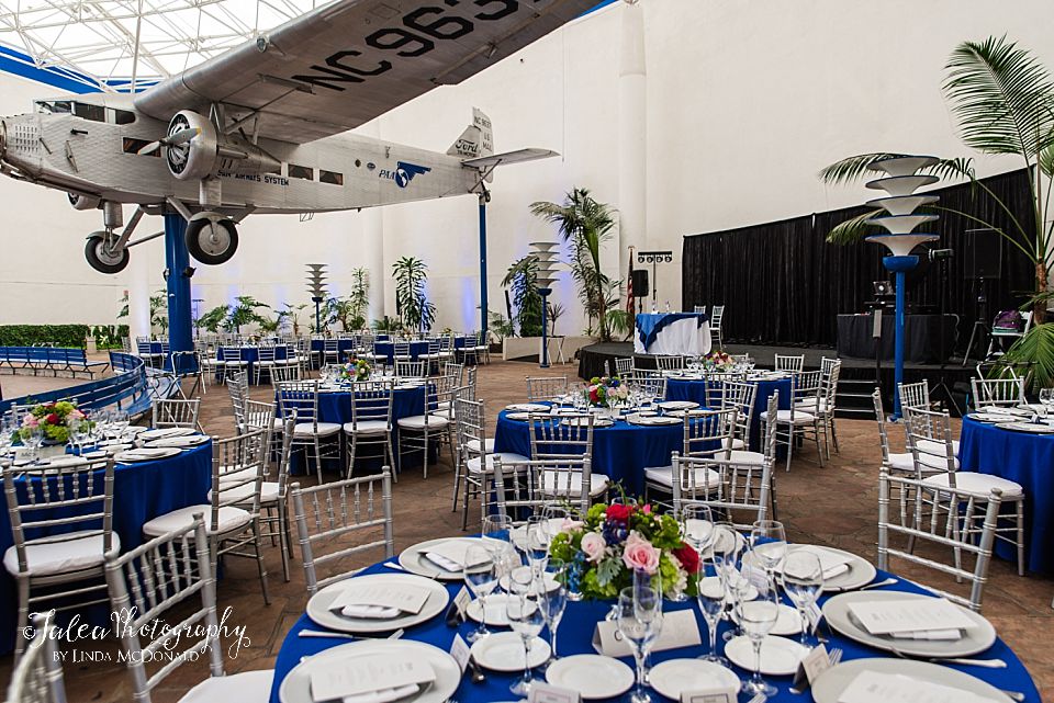 wide angle view of a wedding reception room setup at San Diego Air and Space Museum