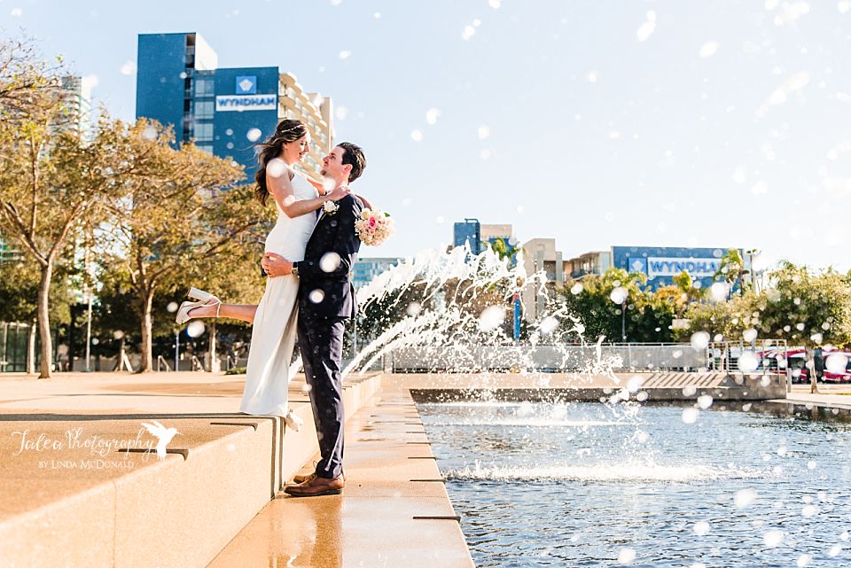 Newlyweds standing in fountains at Waterfront Park after their San Diego Courthouse Wedding