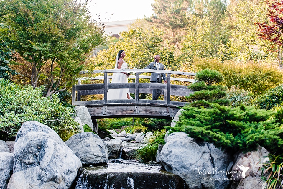 Black couple in wedding attire walking hand in hand at Japanese Friendship Garden wedding Balboa Park 